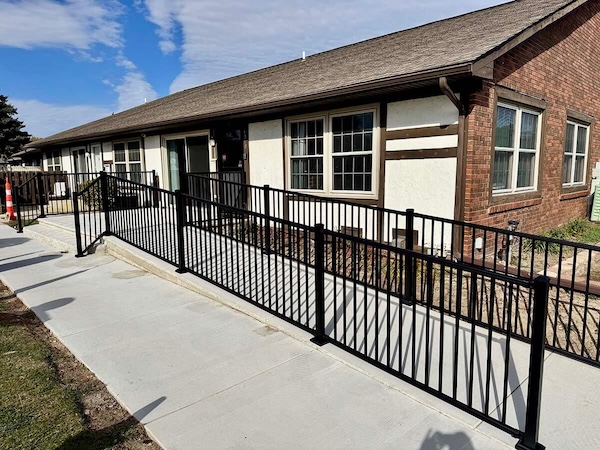 Black Aluminum Railing Installation Along Commercial Walkway