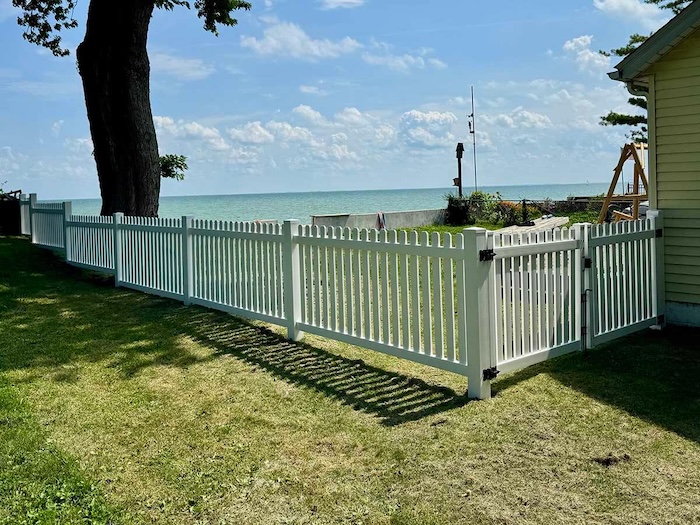 White Vinyl Picket Fence Installation Near Waterfront Property